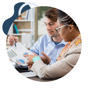 man explaining to woman the financial reporting in chart format that may be included in fractional CFO services